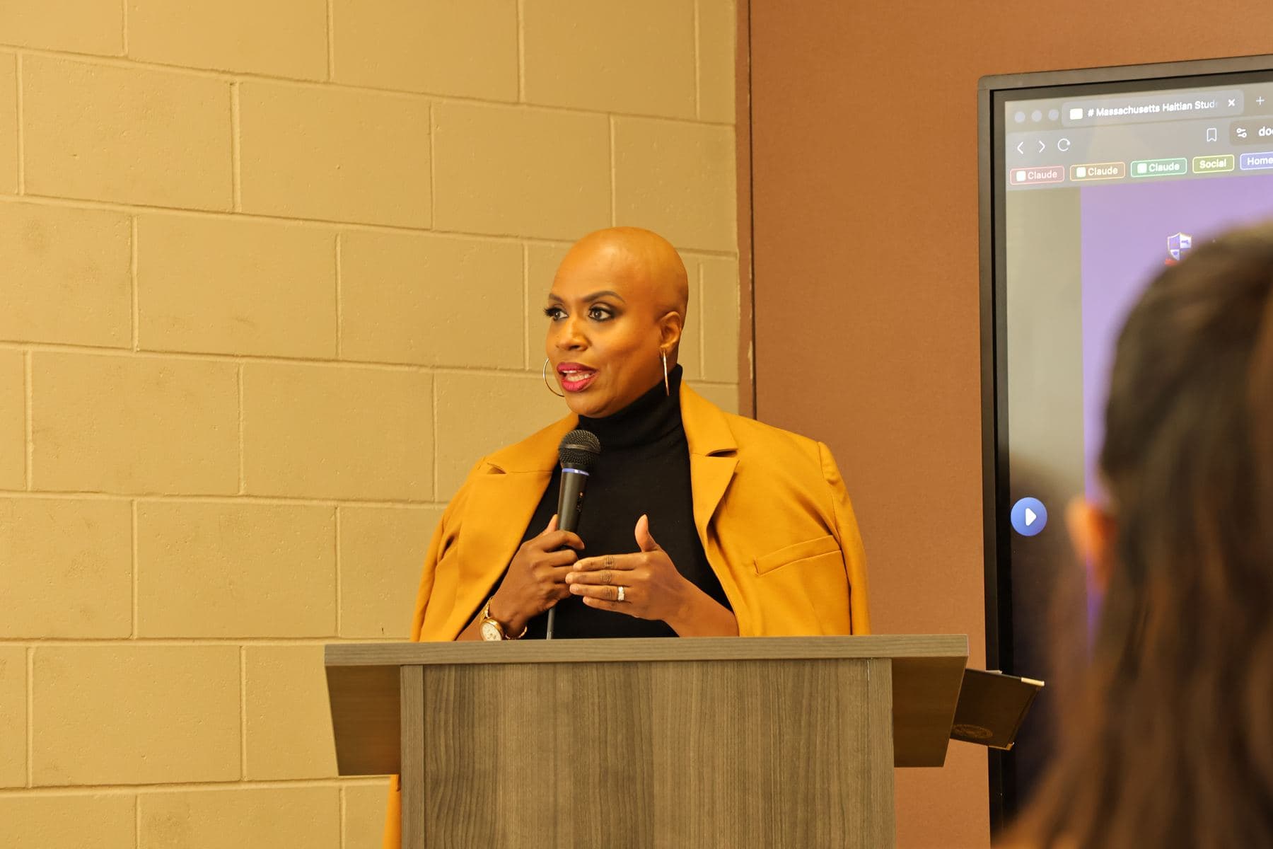 Congresswoman Ayanna Pressley speaking at a podium