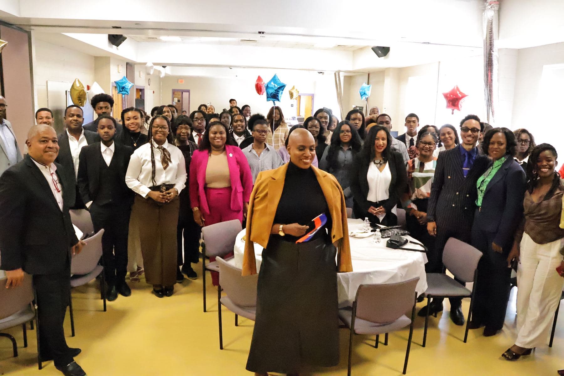 Congresswoman Ayanna Pressley standing with a large group of students and guests
