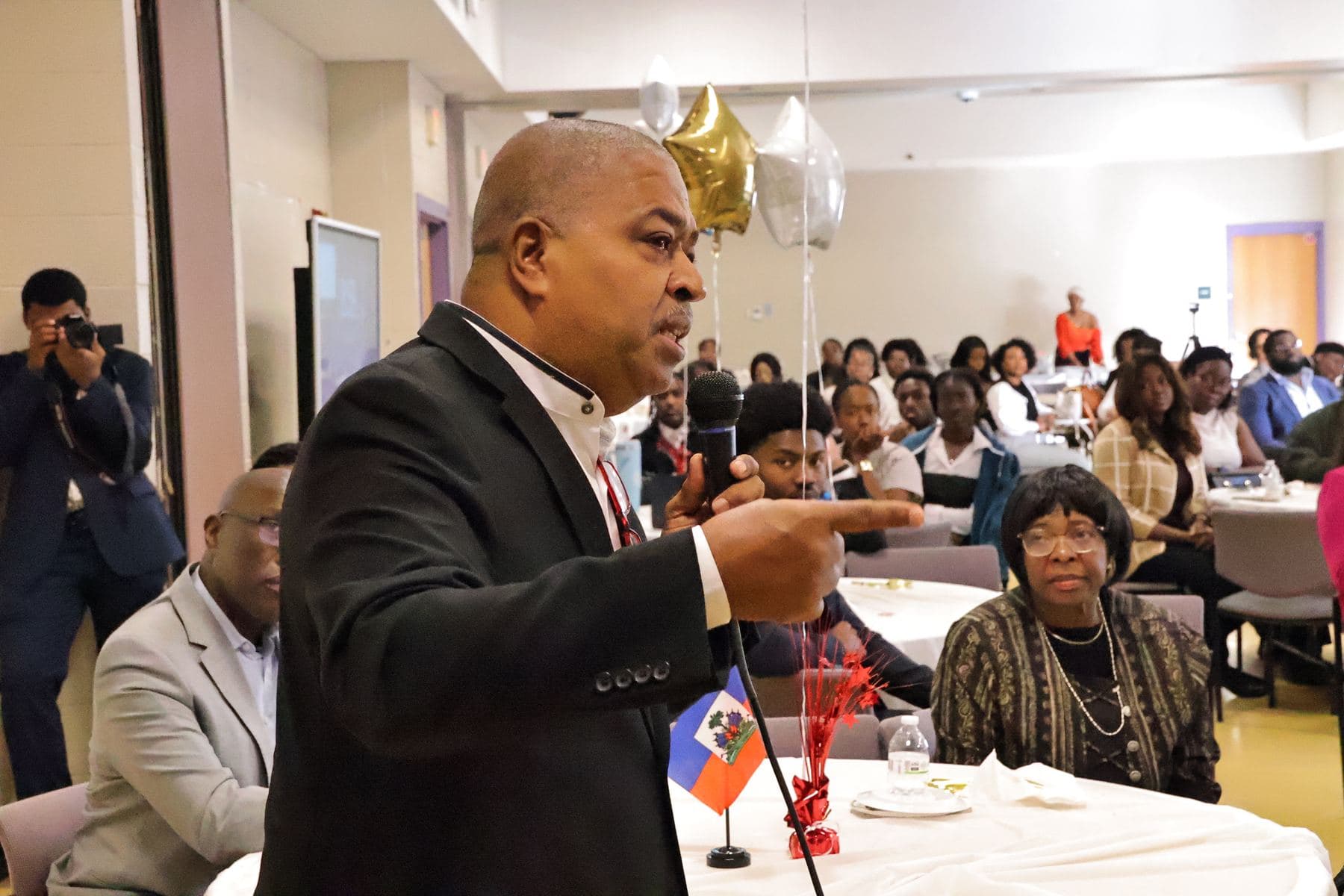 A guest speaking into a microphone from the audience