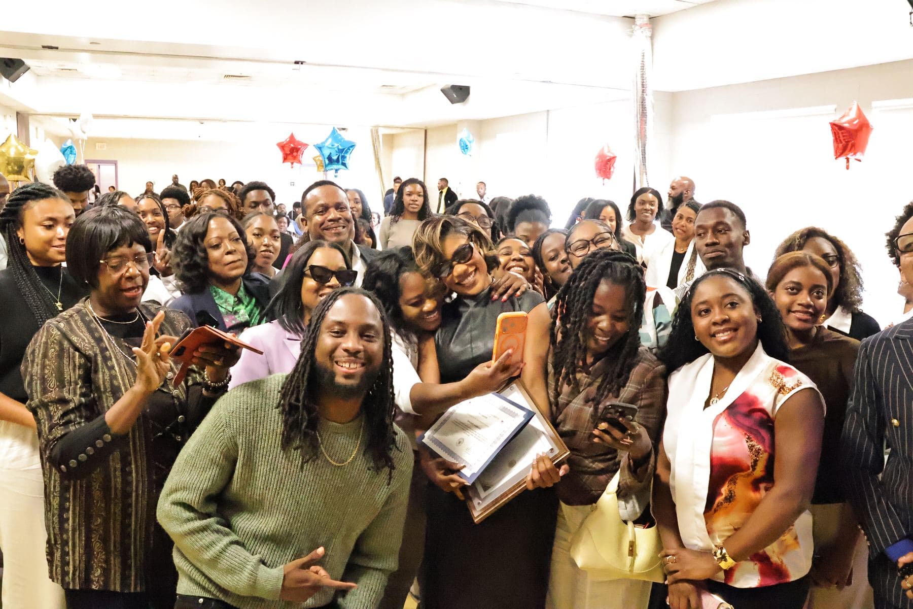 Students crowding around Rutshelle Guillaume for photos